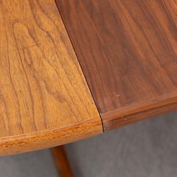 A walnut vereered dining table, mid 20th Century.