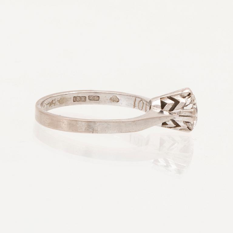 An 18K white gold solitaire ring set with a round brilliant cut diamond.