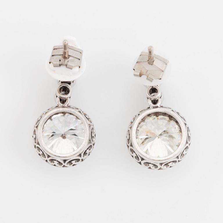 A pair of platinum earrings set with round brilliant- and old-cut diamonds.