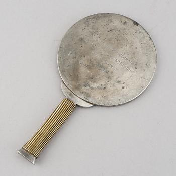 Estrid Ericson & Björn Trädgårdh, a pewter and brass handmirror from Firma Svenskt Tenn.