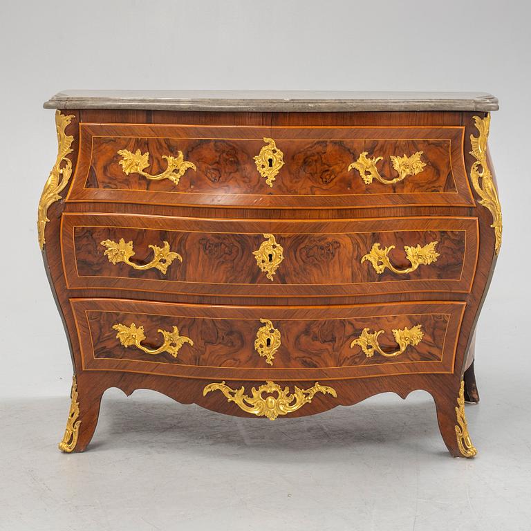 A Swedish rococo parquetry and gilt-bronze mounted commode in the manner of C. W. Hein, later part of the 18th century.