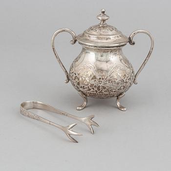A Pakistan silver coffee pot, sugar bowl, sugar tongs and creamer.