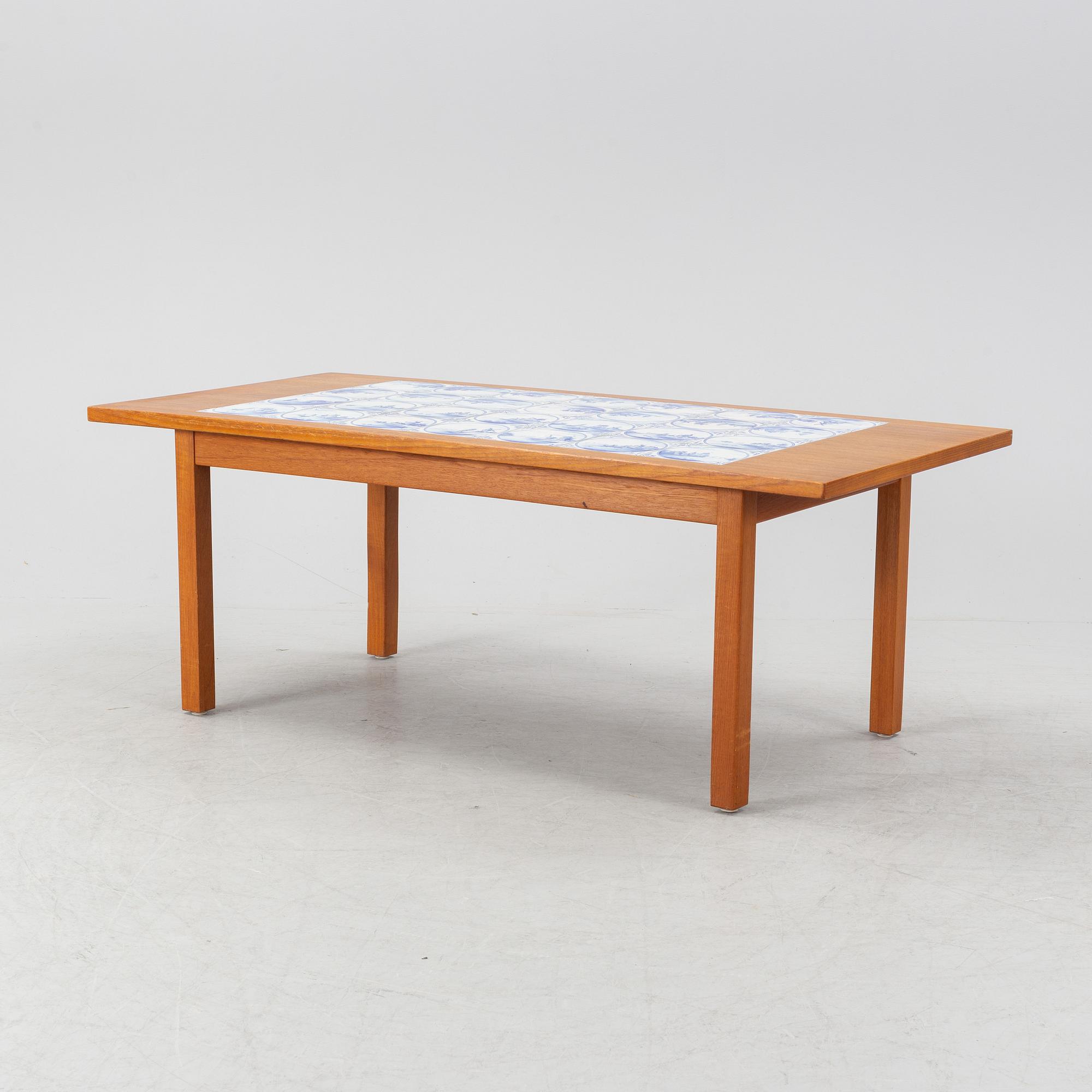 A teak coffee table with inlaid tiles. Second half of the 20th Century.