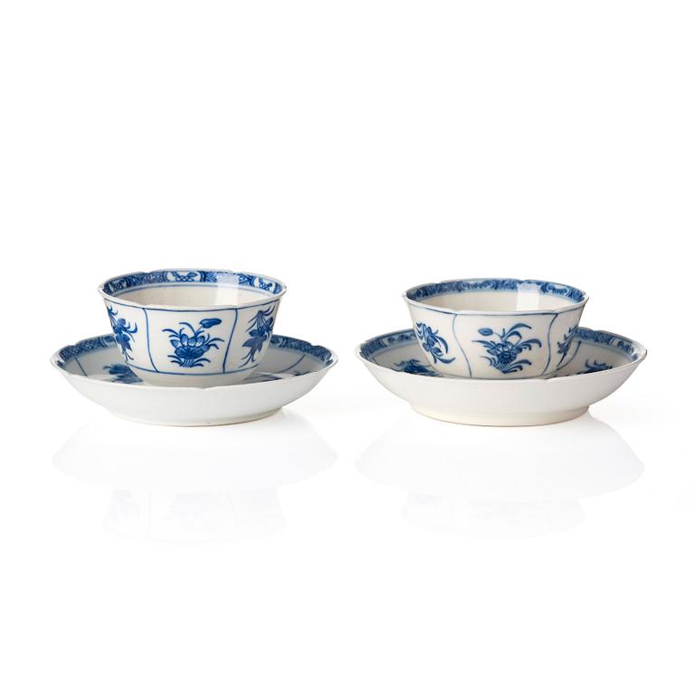 A pair of blue and white 'soft paste' cups with saucers, Qing dynasty, Kangxi (1662-1722).