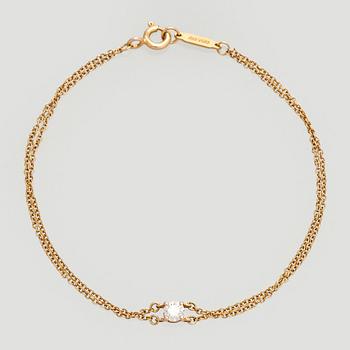 Tiffany & Co, an 18K gold bracelet with a brilliant-cut diamond.