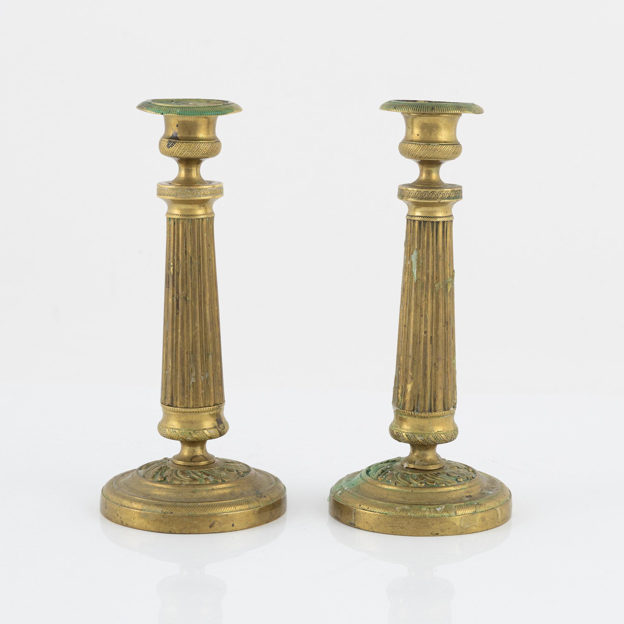 A pair of Empire bronze candlesticks, first half of the 19th Century.