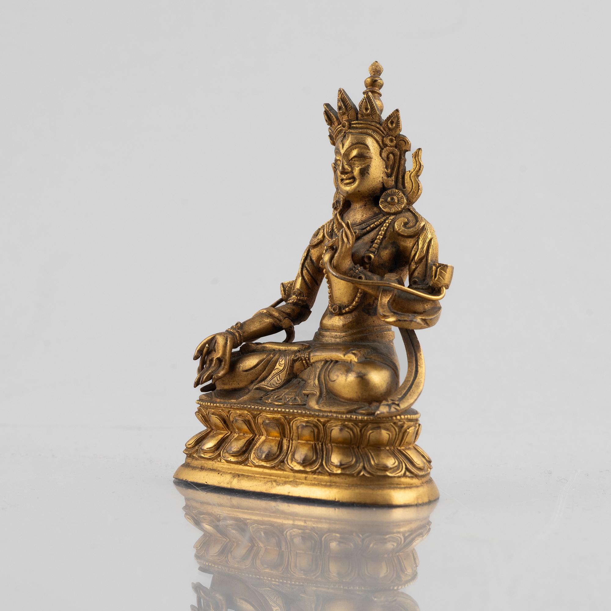 A gilt copper figure of a Buddha, 20th century.