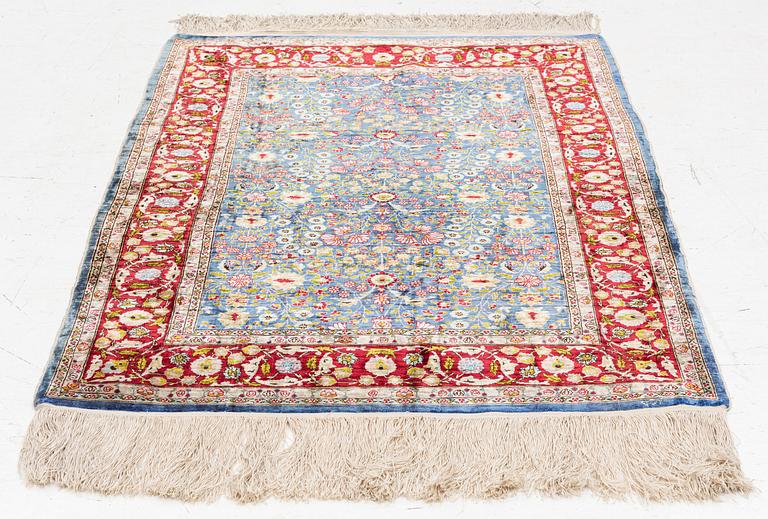 An Oriental silk rug, signed, c. 125 x 85 cm.