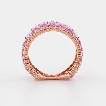 An emerald cut pink sapphire and brilliant cut diamond ring.