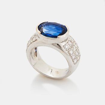 503. An 18K white gold ring set with an oval faceted sapphire and round brilliant-cut diamonds.