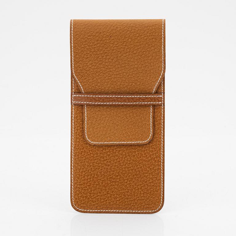 Hermès, a brown leather case for sunglasses.