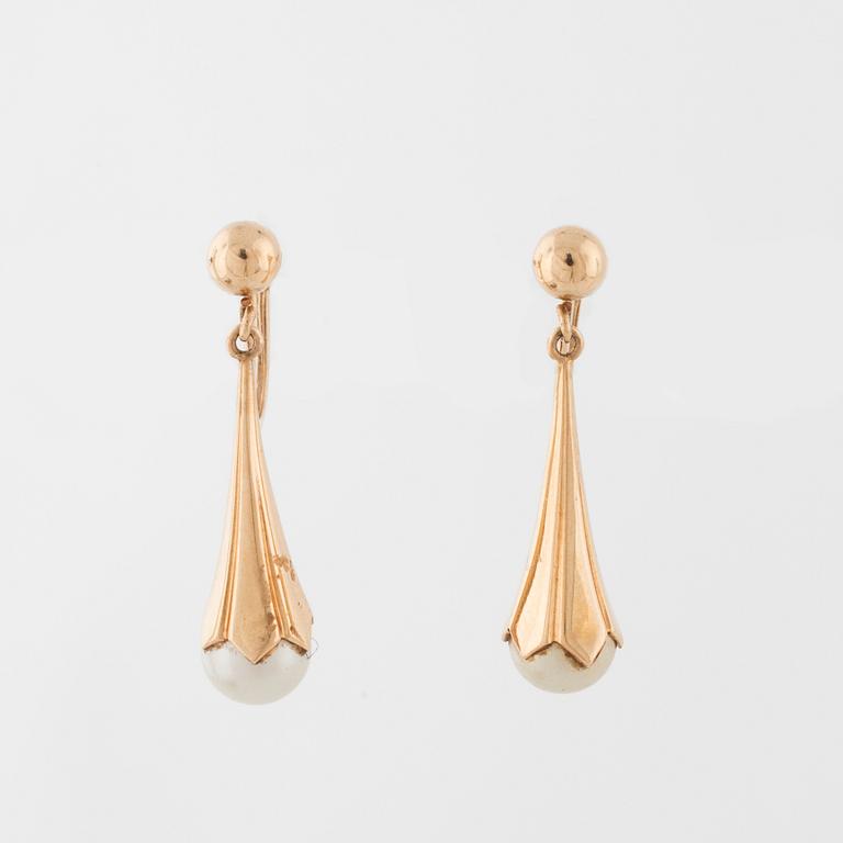 A pair of cultured pearl earrings.