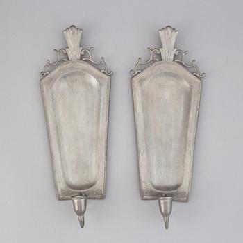 A pair of 20th century pewter wall sconces for ine candle.