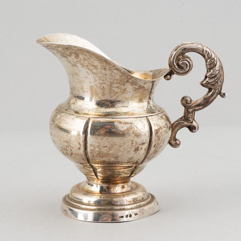 A mixed lot of two 19th century silver and parcel-gilt creamers and a coffee-pot.