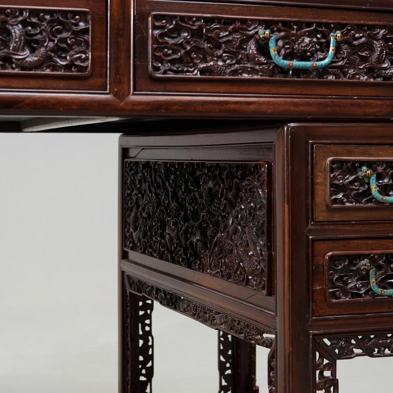 A carved hardwood desk, late Qing dynasty, circa 1900.