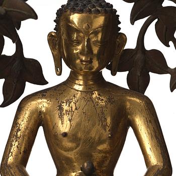 A large Nepalese gilt bronze buddha on a throne with mandorla, 18/19th Century.