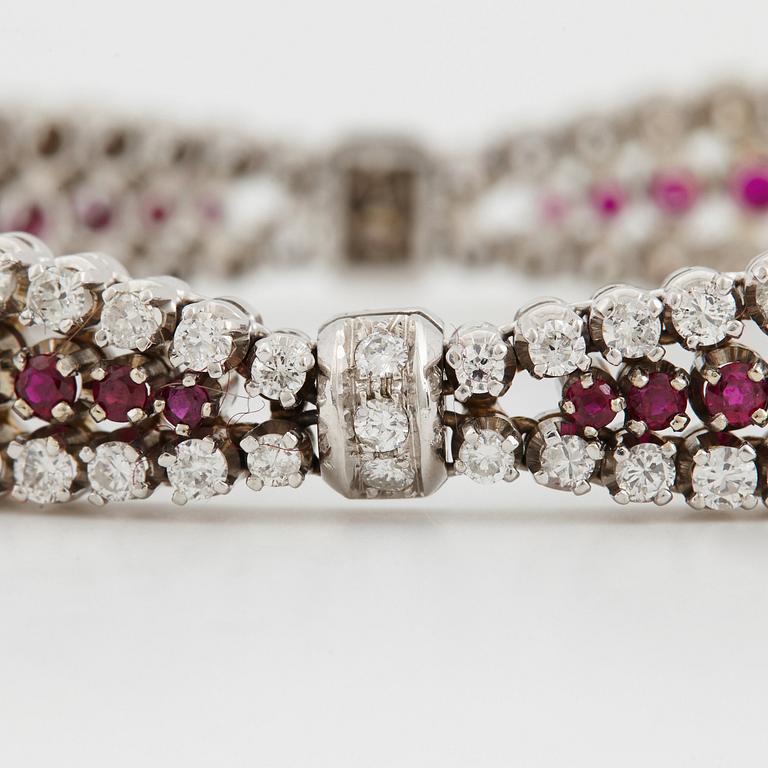 An 18K white gold bracelet set with rubies and round brilliant-cut diamonds.