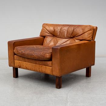 A 1960's/1970's leather covered easy chair with rosewood legs.