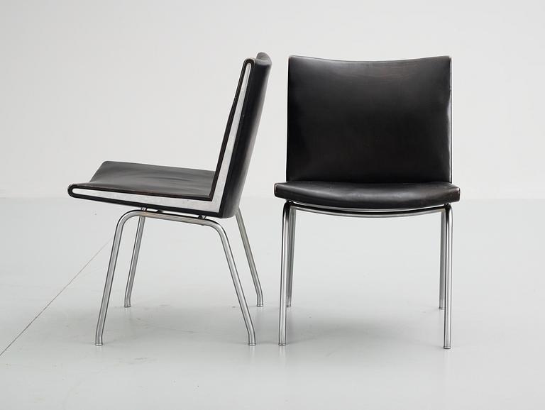 A pair of Hans J Wegner 'Kastrup' steel and black leather chairs, AP-stolen, Denmark.
