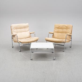 Bruno Mathsson, a pair of easy chairs and a coffee table, 'Karin', Dux, second half of the 20th Century.
