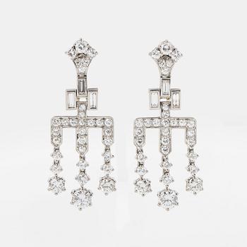 Ett par örhängen med runda briljant- och baguetteslipade diamanter.