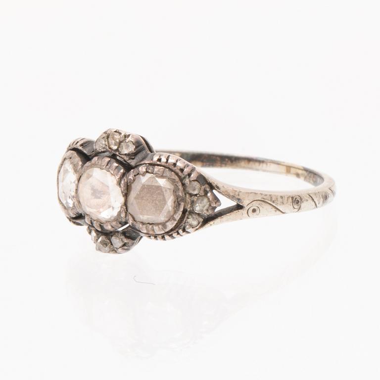 An 18K white gold ring set with rose cut diamonds.