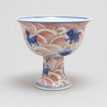 A Chinese ironred decorated blue and white 'Mythical sea creature' stem cup, 20th century.