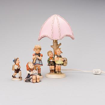 A set of three porcelain figurines and a desk light,  Goebel Porzellanfabrik, Germany.