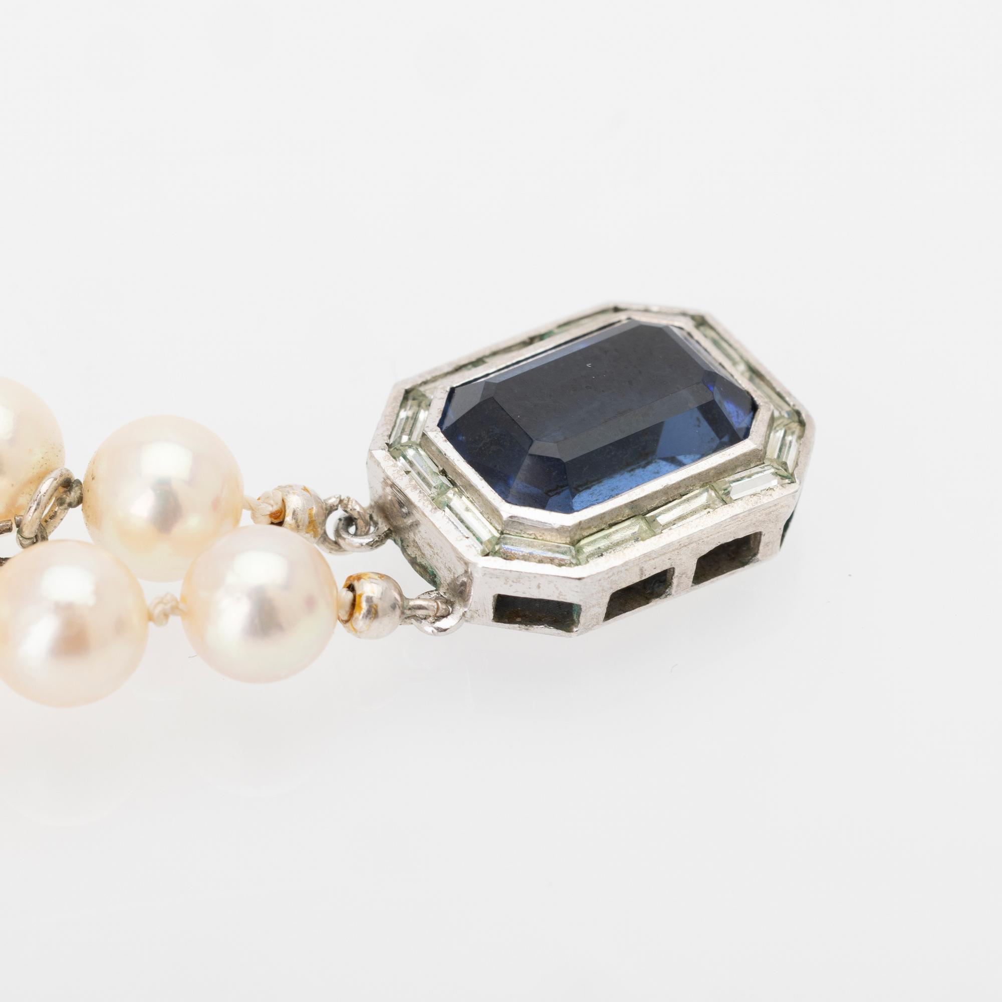 Two-row cultured pearl necklace with a silver and glass clasp.