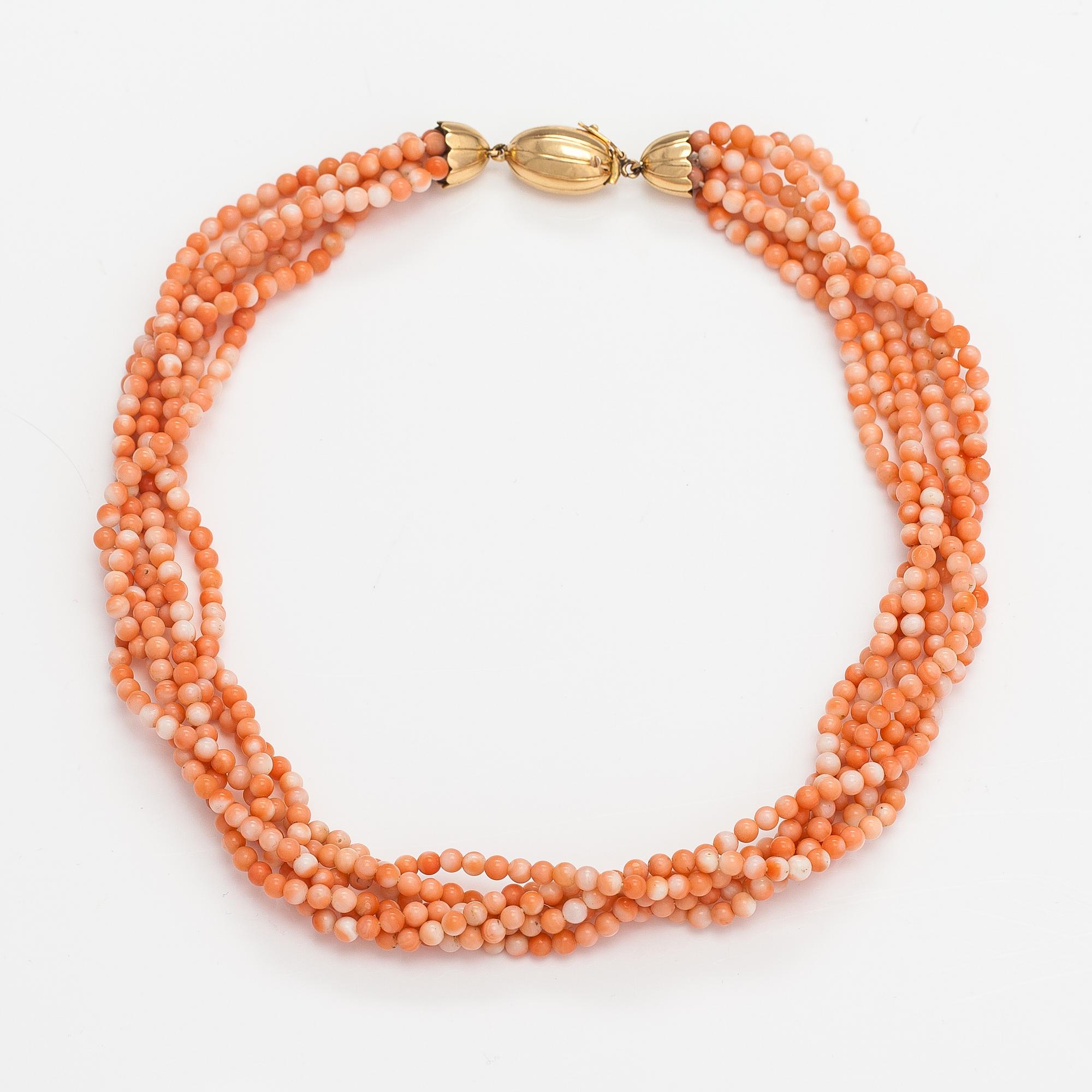 A 6-strand pearl collier with coral pearls and an 18K gold clasp.