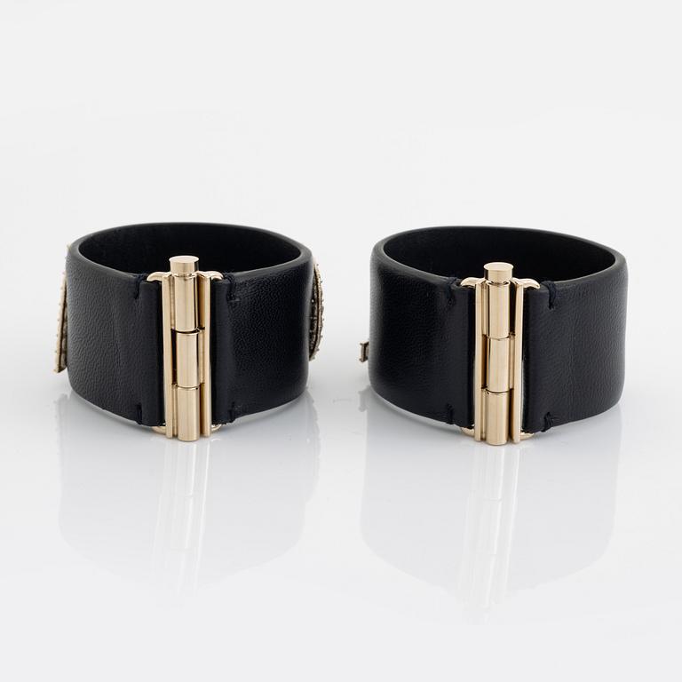 Chanel, a pair of black leather and rhinestone bracelets.