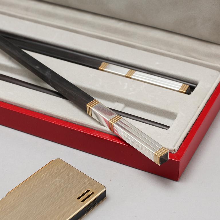 Three ligthers by Pierre Cardin, Ronson and Zippo and shopsticks and a scent bottle from Christofle.