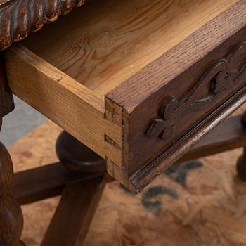 An early 20th Century oak side table with a stone top.
