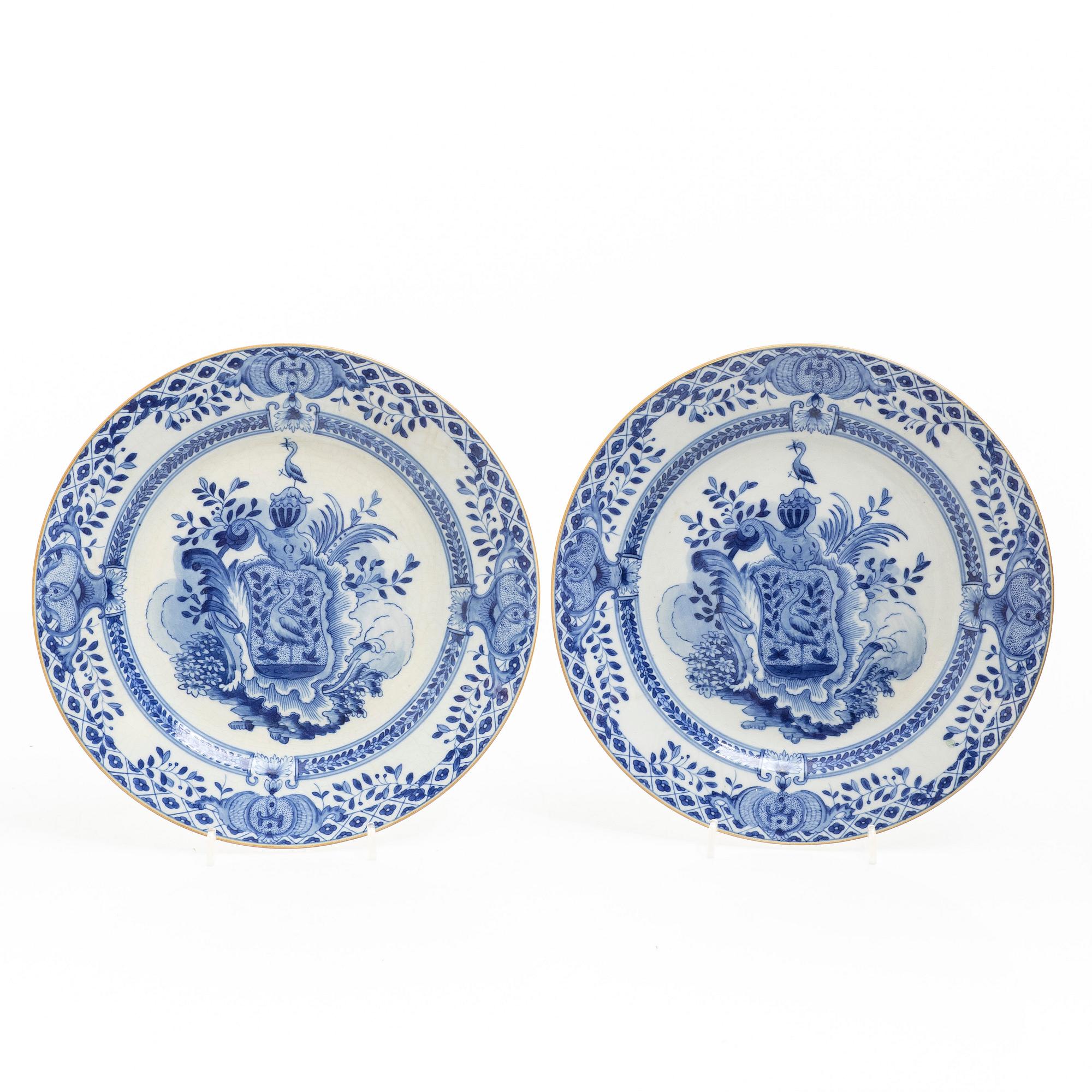 A pair of armorial dinner plates, soft paste, Qing dynasty, 18th century.