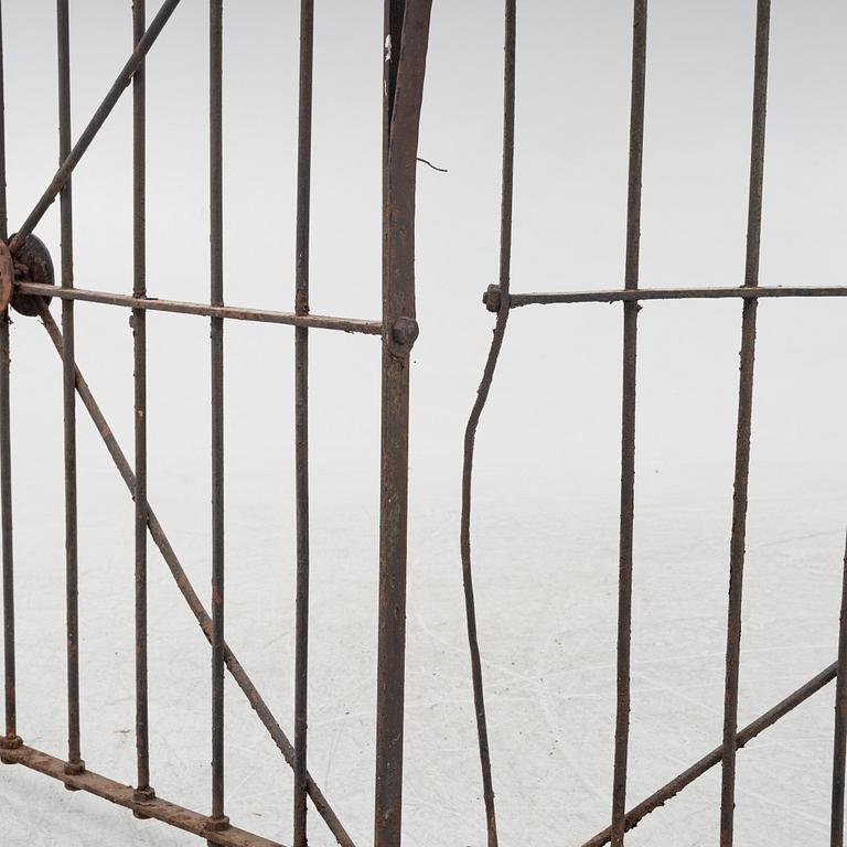 A pair of iron garden gates and a single gate from the early 20th century.