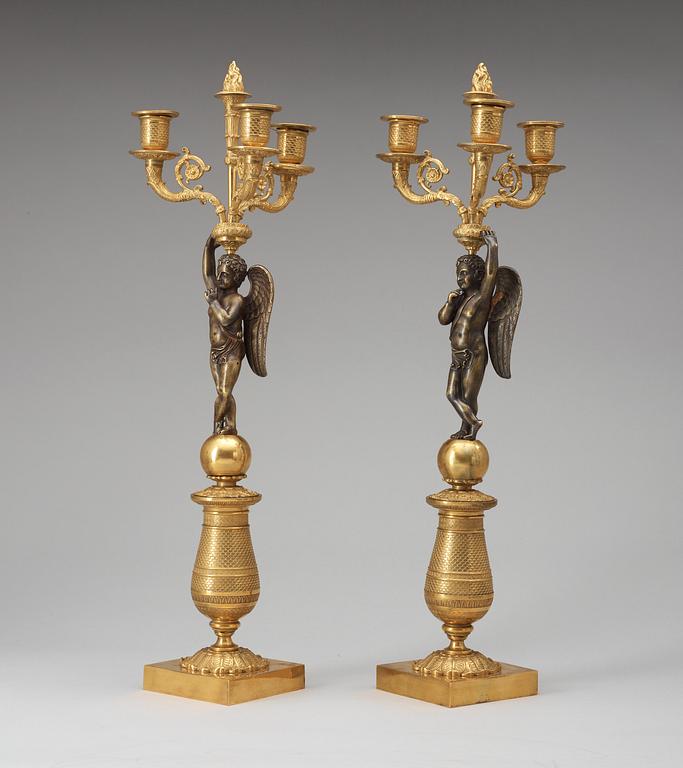 A pair of French Empire early 19th century three-light candelabra.