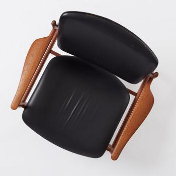 Finn Juhl, a teak and black leather 'model 136' easy chair, France & Daverkosen, Denmark 1950-60s.