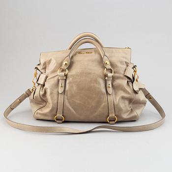 Miu Miu, a leather handbag.