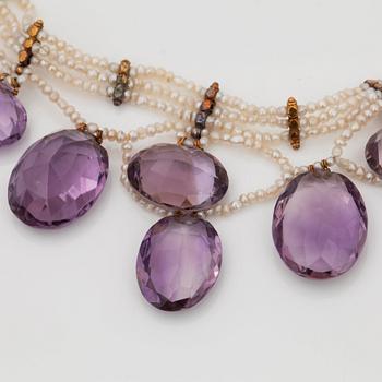 An amethyst and probably natural seed pearl necklace.