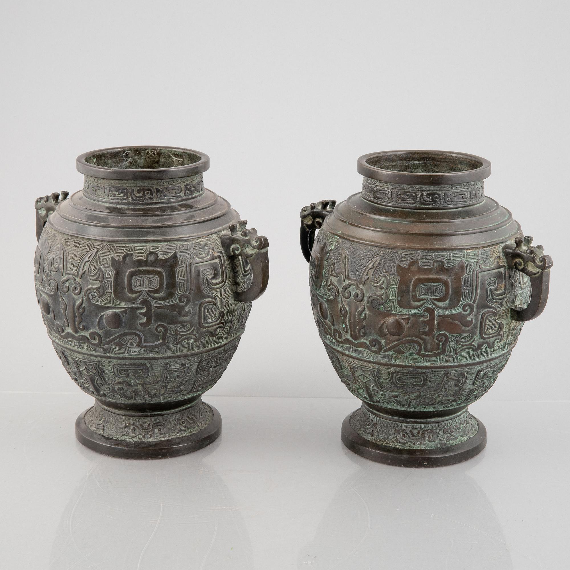 A pair of Chinese bronze urns, 20th century.