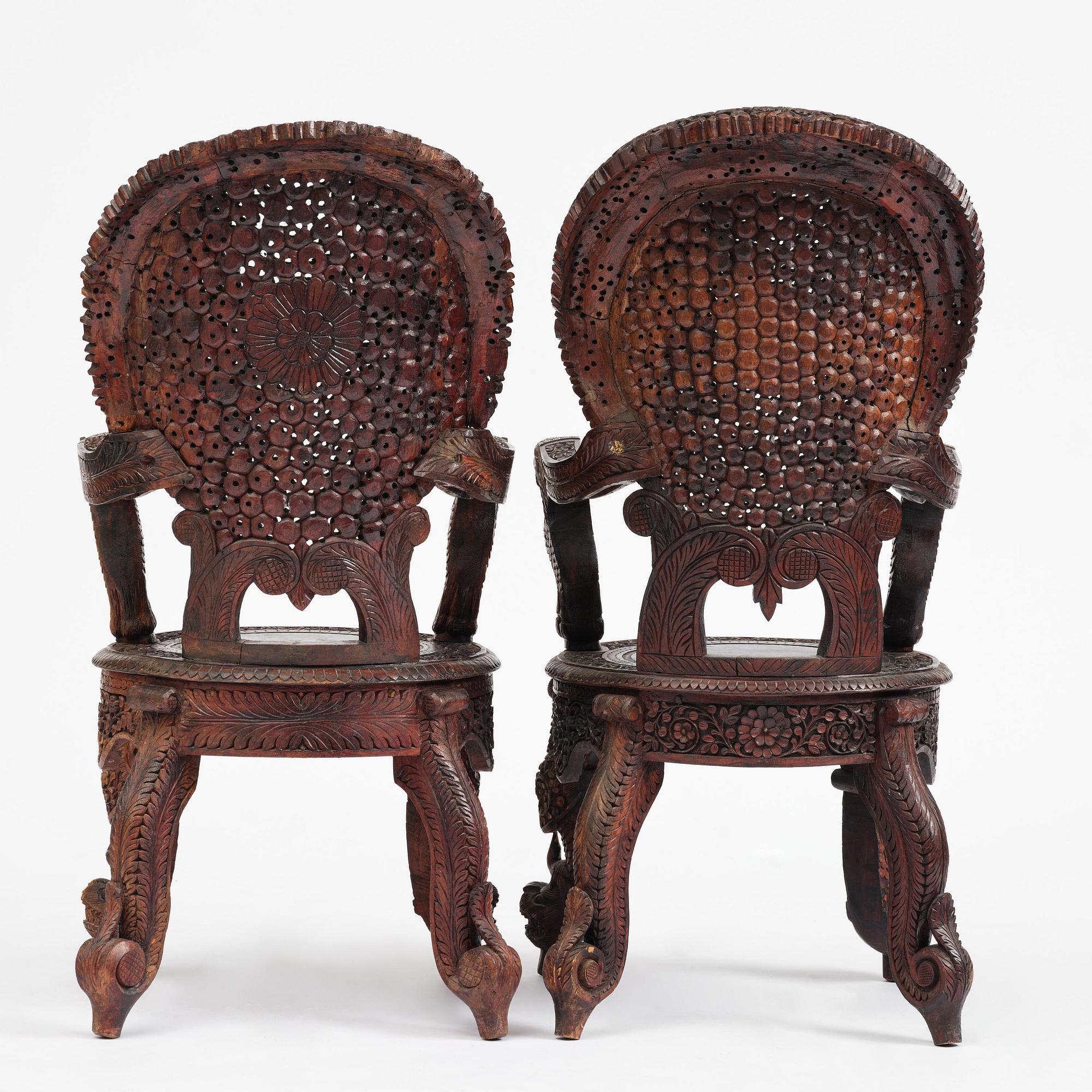 A pair of carved 'blackwood' armchairs, Bombay presidency, British Raj, circa 1880.