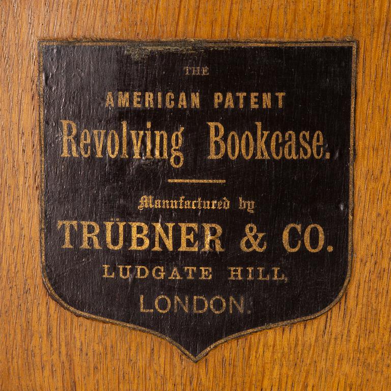 An oak Revolving bookcase by Trübner & Co, England, early 20th century.