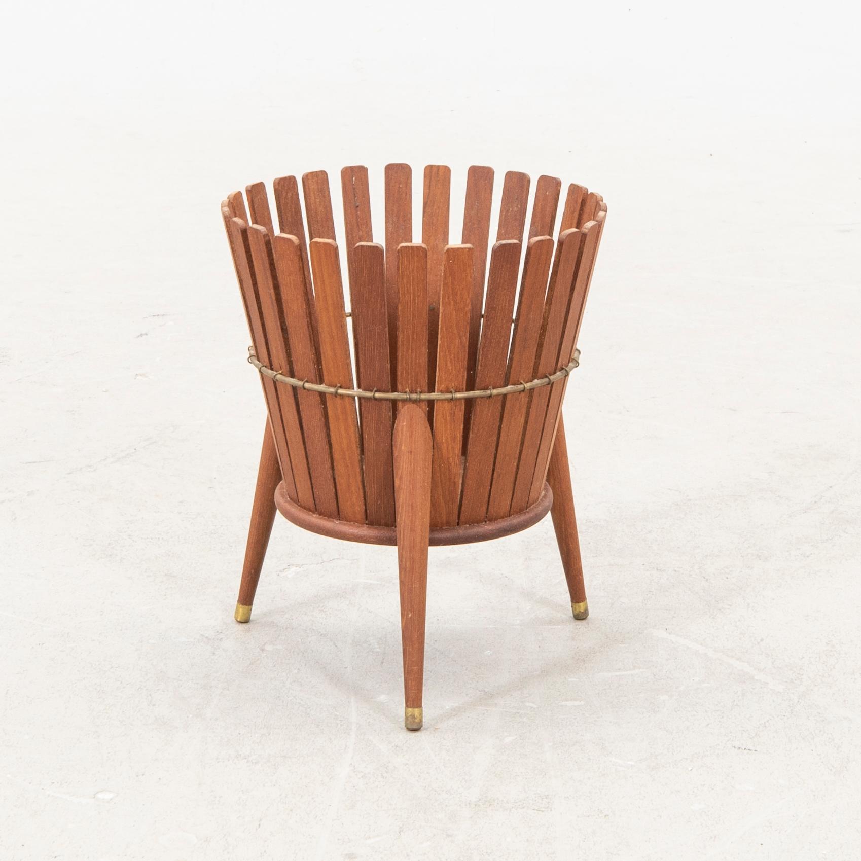 A 1950s teak wastepaper basket.