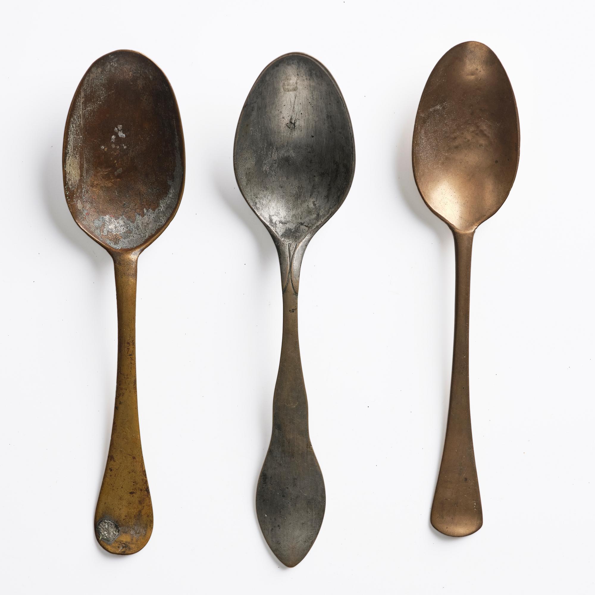 A set of three brass spoons, 18th century.