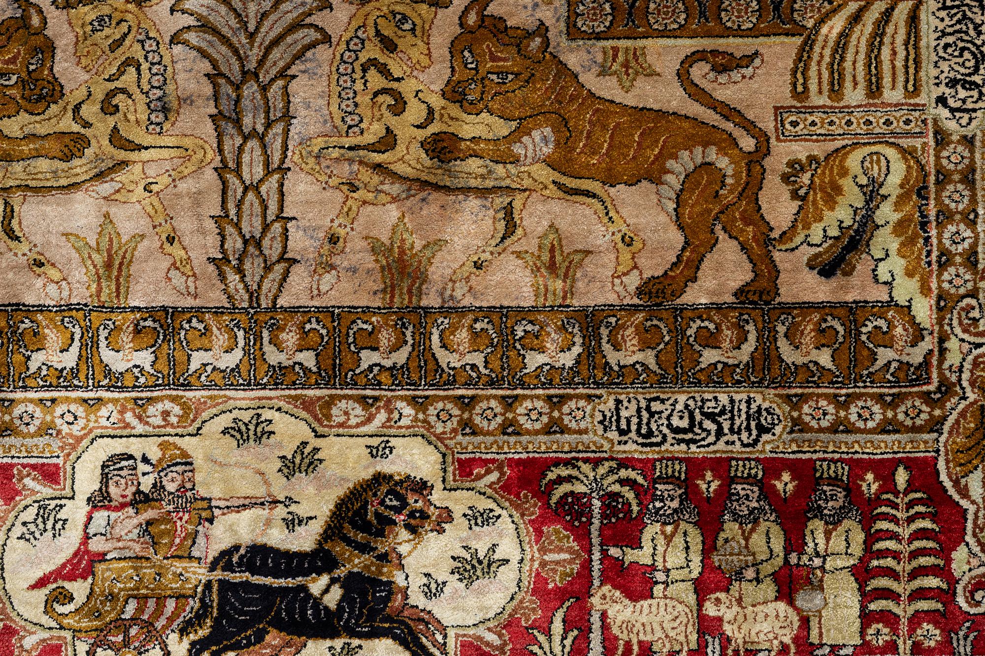 A pictorial semi-antique silk Qum rug, central Persia, c. 214 x 146 cm.