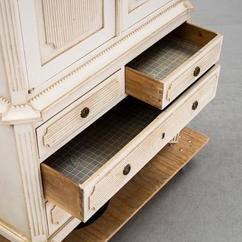 A gustavian style cabinet, circa 1900.