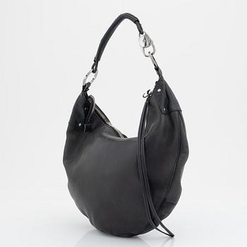 Gucci, a leather bag.