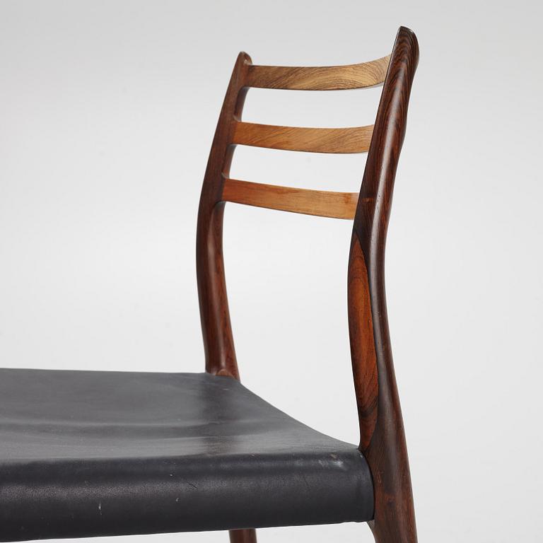 Niles Otto Møller, a rosewood veneered table with four chairs, JL Møller, Denmark, 1950's/60's.