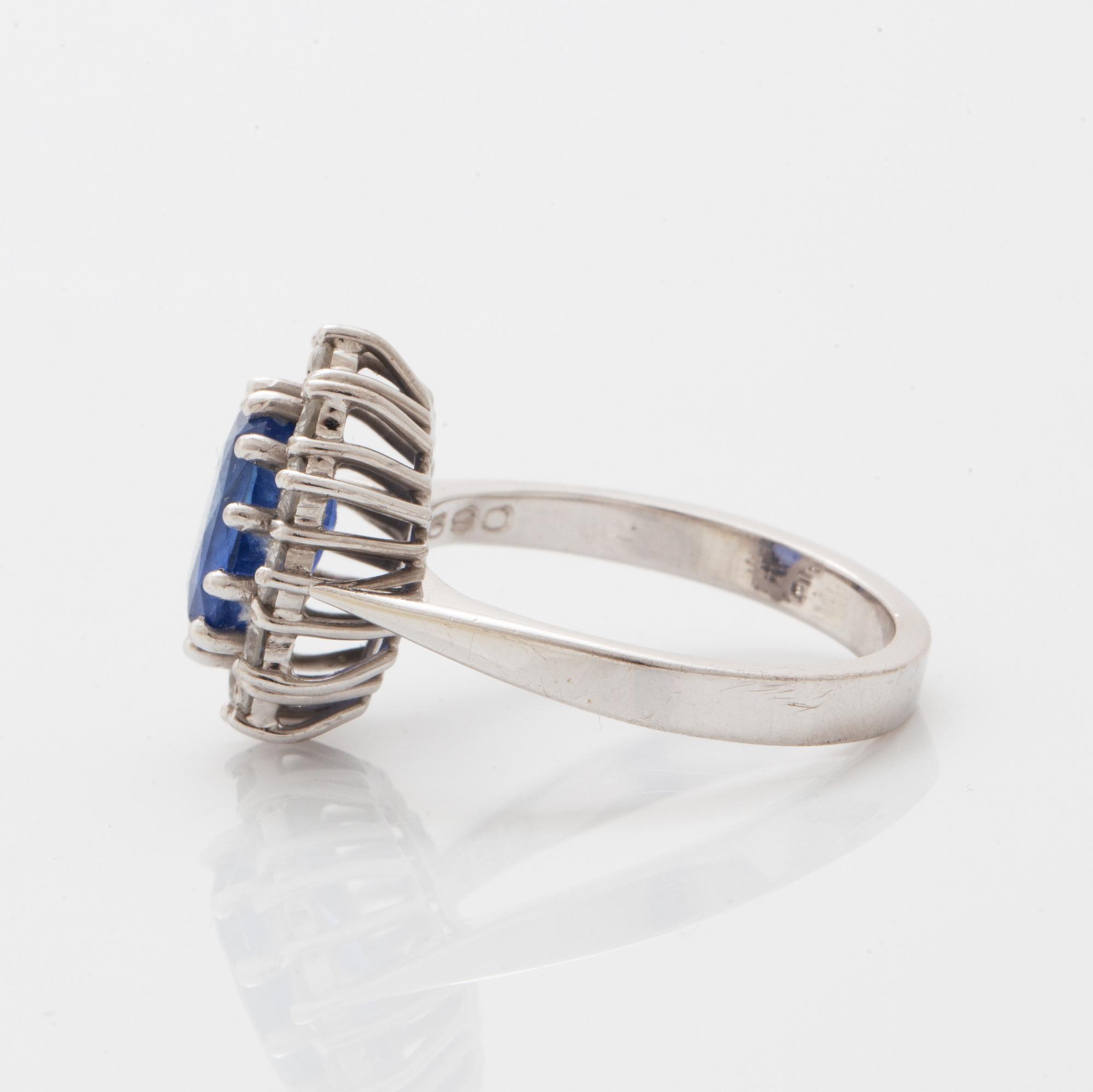 Oval faceted sapphire and brilliant-cut diamond ring.