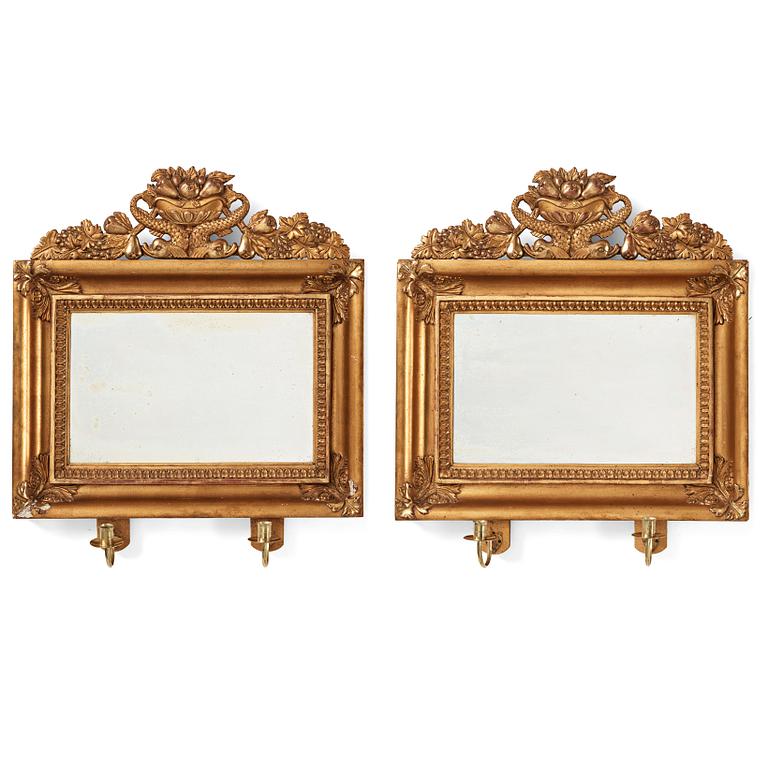 A pair of Swedish Empire two-light girandole mirrors, first half of the 19th century.